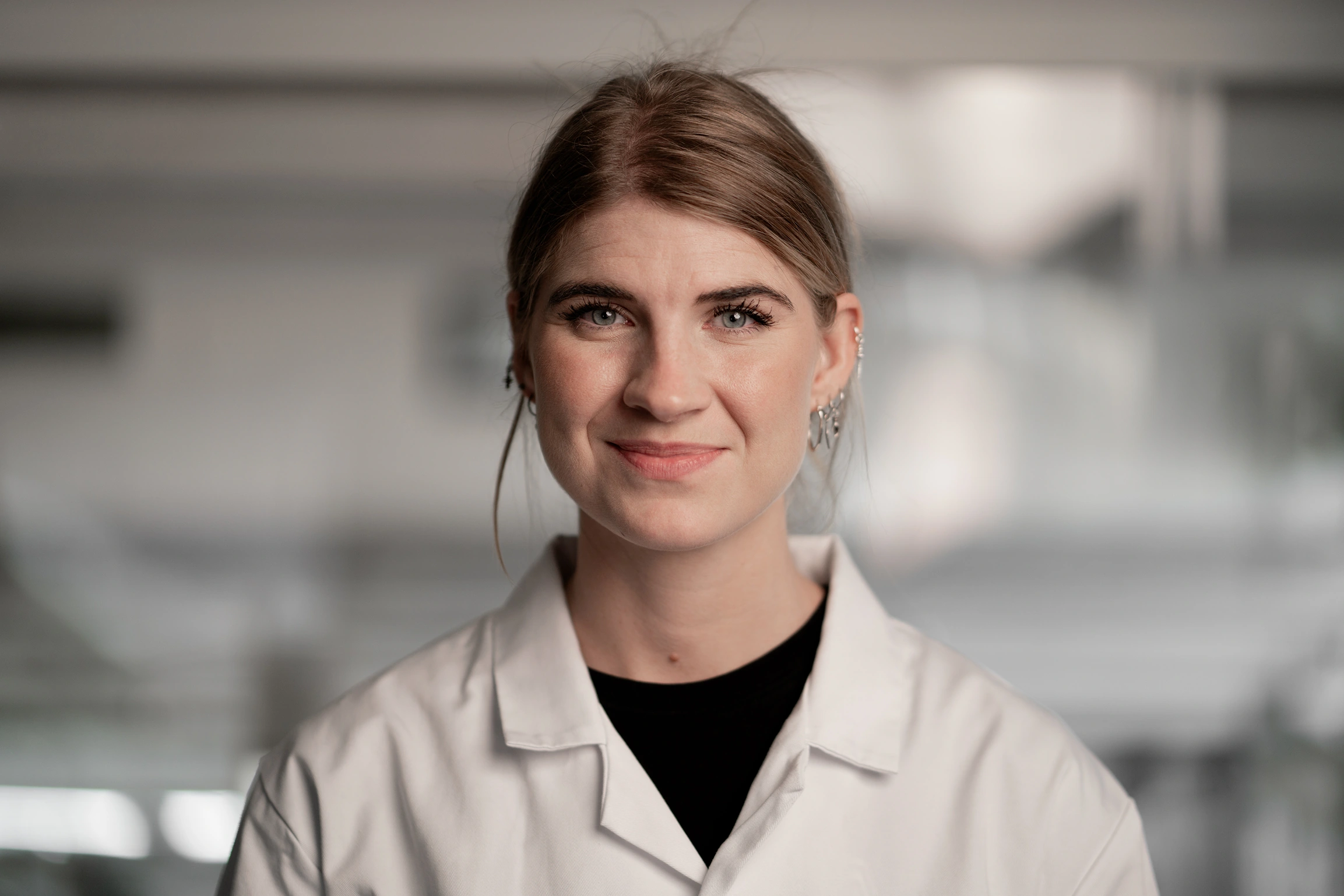 Portrait of Signe Larsen, Development Engineer at Subra, working in the lab.